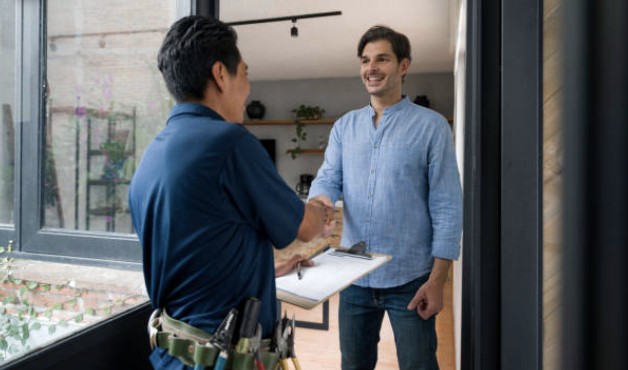 Terrashield estimator shaking hands with a happy homeowner at the front door